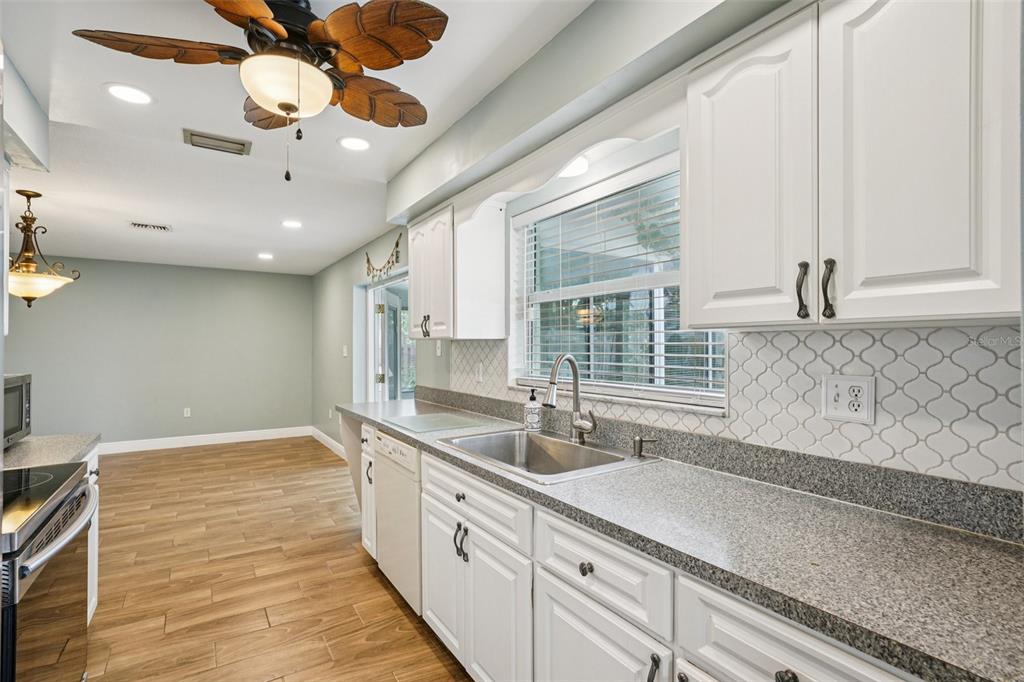 1118 Carlton Road Tarpon Springs, FL 34689 - Photo 19 of 62 a spacious bathroom with a granite countertop sink a large mirror and a bathtub