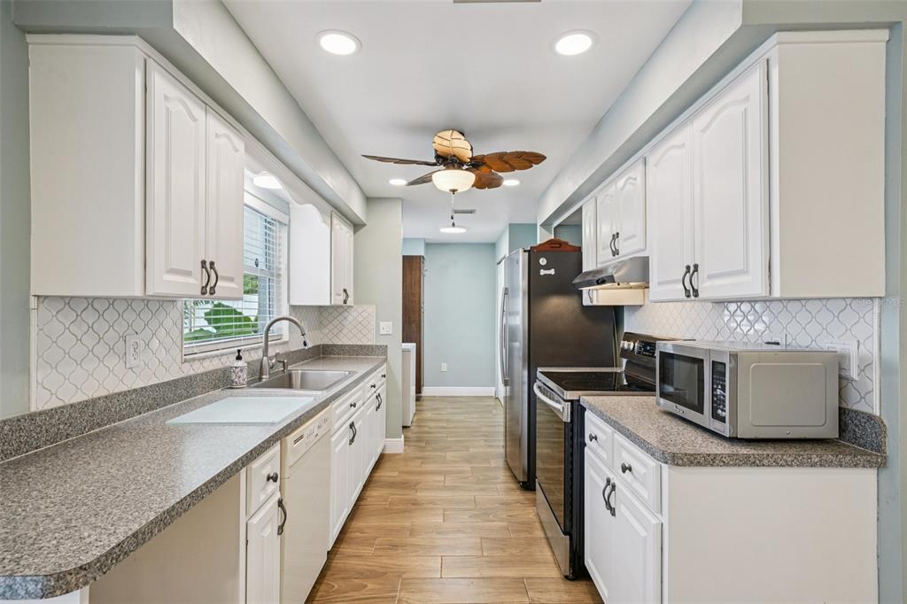 1118 Carlton Road Tarpon Springs, FL 34689 - Photo 20 of 62 a kitchen with granite countertop a sink and refrigerator