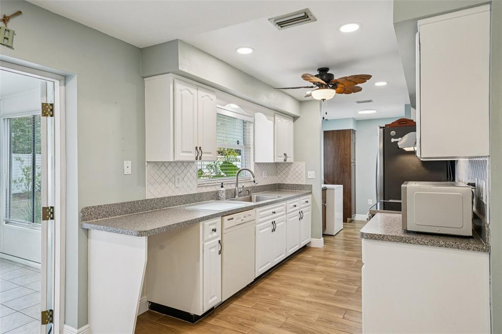 1118 Carlton Road Tarpon Springs, FL 34689 - Photo 22 of 62 a kitchen with stainless steel appliances granite countertop a sink a stove and a refrigerator