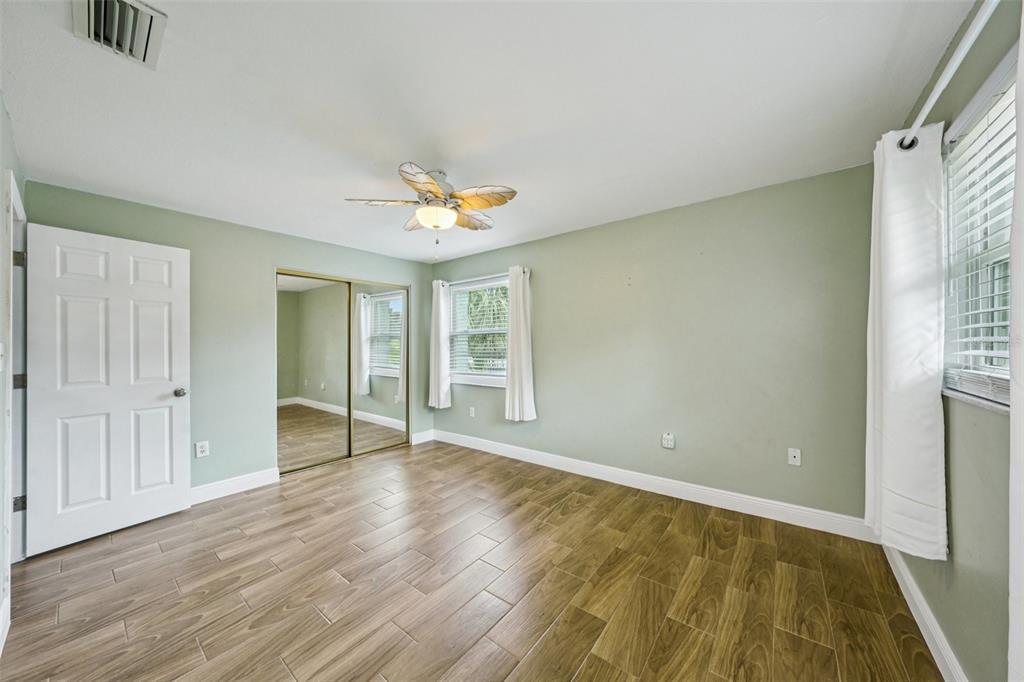 1118 Carlton Road Tarpon Springs, FL 34689 - Photo 26 of 62 a view of an empty room with wooden floor and a window