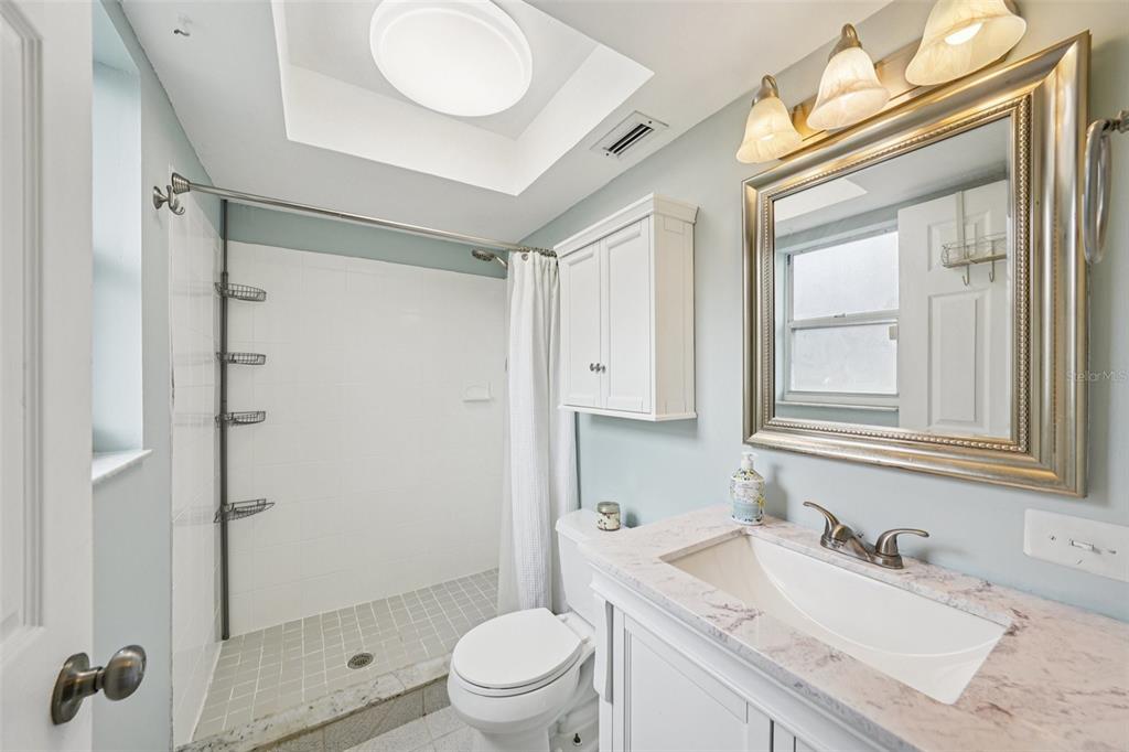 1118 Carlton Road Tarpon Springs, FL 34689 - Photo 28 of 62 a bathroom with a sink toilet vanity and shower