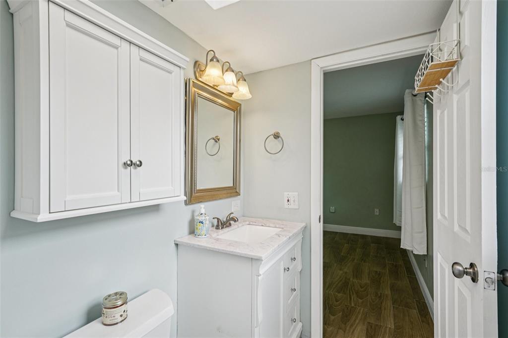 1118 Carlton Road Tarpon Springs, FL 34689 - Photo 29 of 62 a bathroom with a sink and a mirror