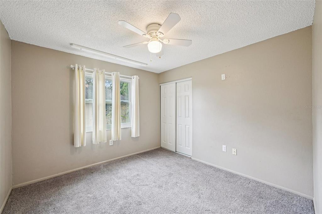 1118 Carlton Road Tarpon Springs, FL 34689 - Photo 30 of 62 an empty room with windows and ceiling fan