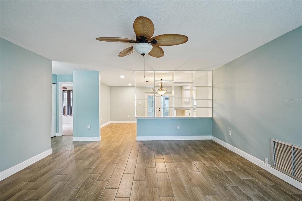 1118 Carlton Road Tarpon Springs, FL 34689 - Photo 3 of 62 a view of empty room with wooden floor and fan