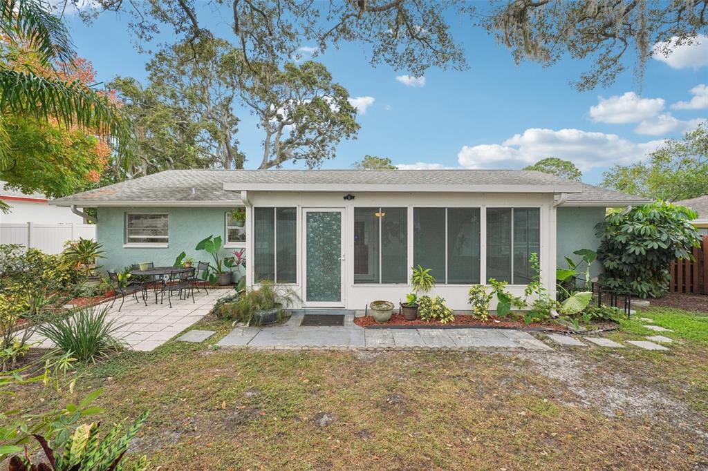 1118 Carlton Road Tarpon Springs, FL 34689 - Photo 40 of 62 a front view of a house with a yard and a garden