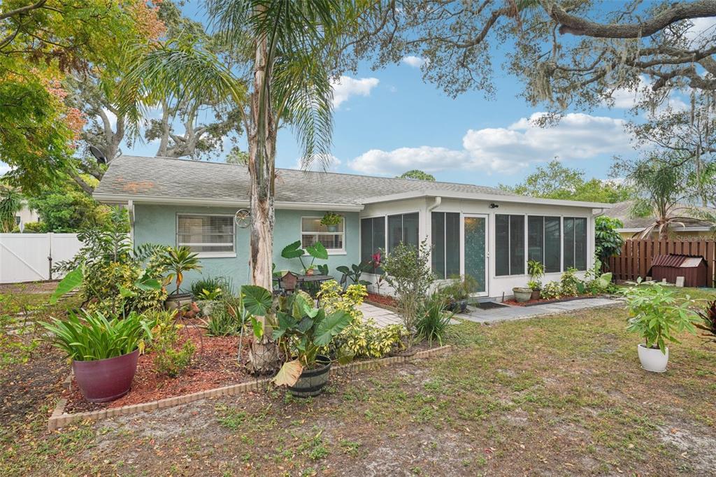 1118 Carlton Road Tarpon Springs, FL 34689 - Photo 42 of 62 a front view of a house with a yard and potted plants