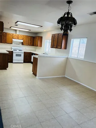 a kitchen with stainless steel appliances granite countertop a sink and cabinets