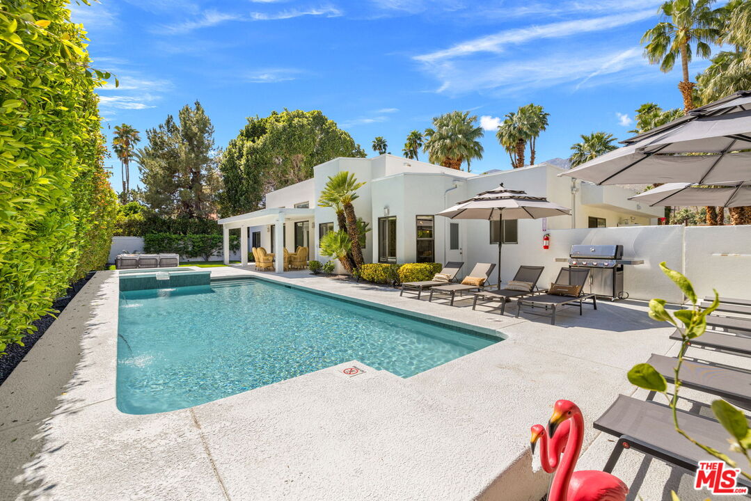 1414 Sagebrush Road Palm Springs, CA 92264 - Photo 2 of 48 a view of a white house with a yard patio and swimming pool