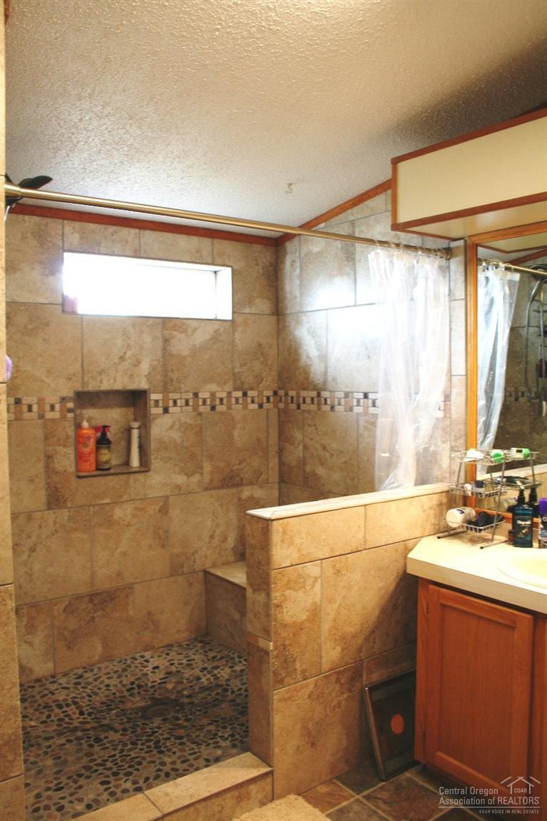 61153 Ropp Lane Bend, OR 97702 - Photo 11 of 25 a bathroom with a sink and a shower