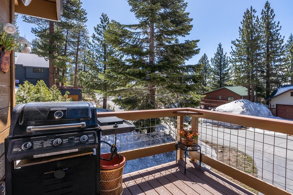 103 Holiday Way Mammoth Lakes, CA 93546 - Photo 16 of 40 a view of a roof deck with wooden bench and trees