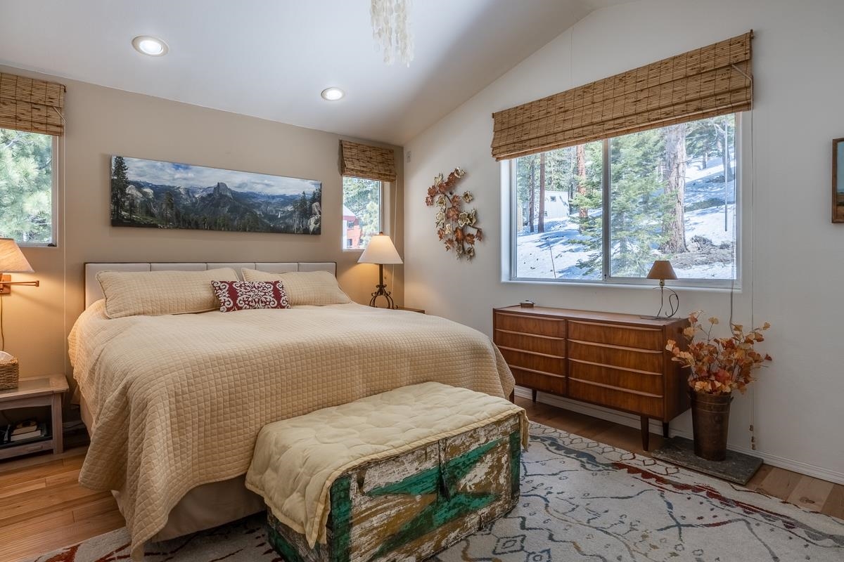 103 Holiday Way Mammoth Lakes, CA 93546 - Photo 18 of 40 a bedroom with a bed and a painting on the wall