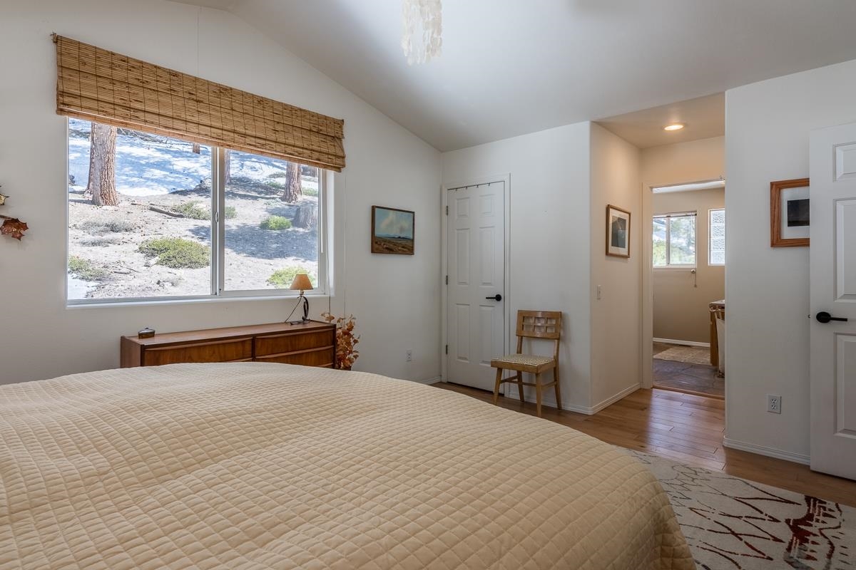 103 Holiday Way Mammoth Lakes, CA 93546 - Photo 19 of 40 a bedroom with a bed and wooden floor