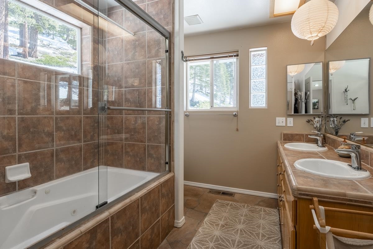 103 Holiday Way Mammoth Lakes, CA 93546 - Photo 22 of 40 a bathroom with a sink a bathtub and next to a window