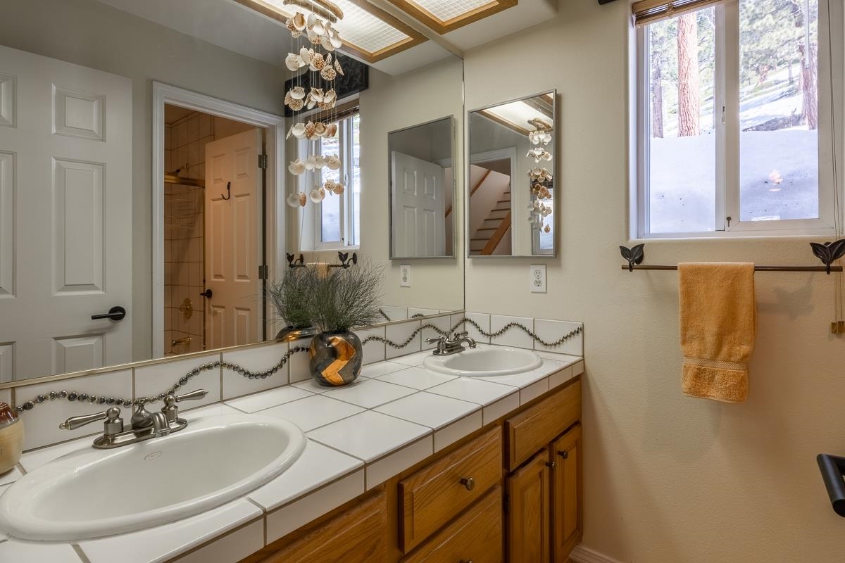 103 Holiday Way Mammoth Lakes, CA 93546 - Photo 26 of 40 a bathroom with a sink double vanity and a mirror