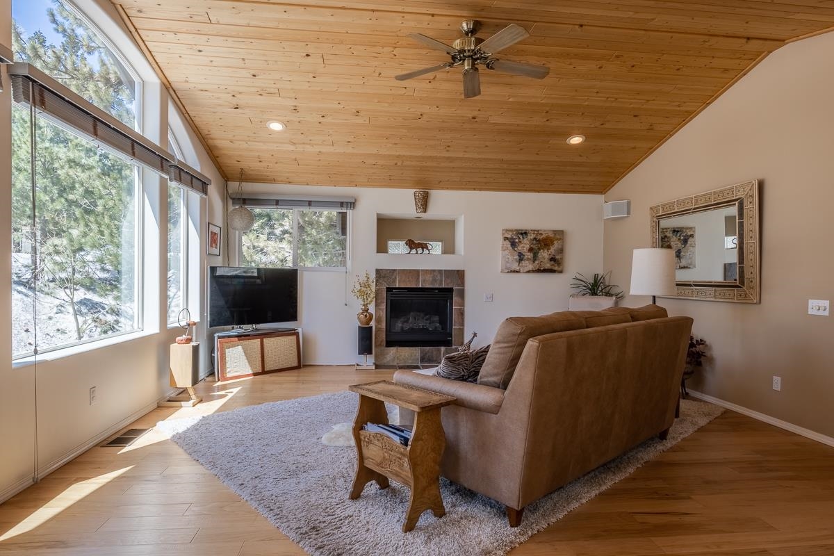 103 Holiday Way Mammoth Lakes, CA 93546 - Photo 6 of 40 a living room with furniture a fireplace and a flat screen tv