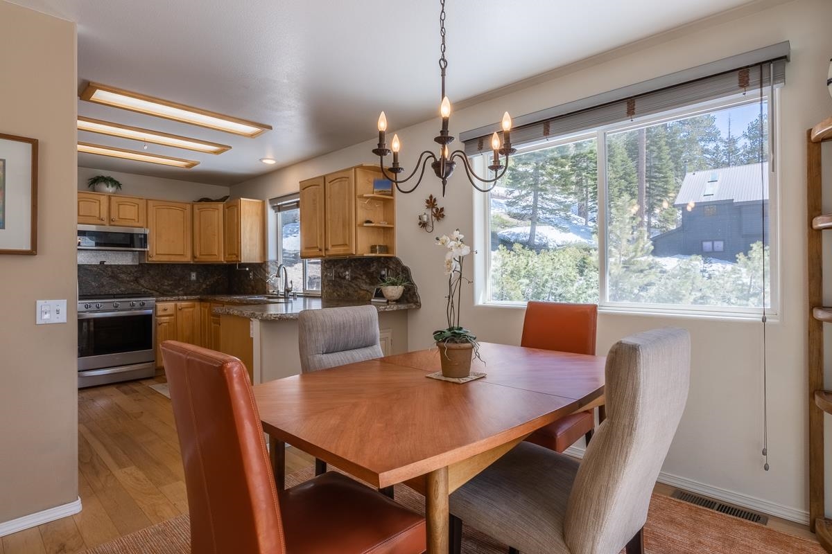 103 Holiday Way Mammoth Lakes, CA 93546 - Photo 9 of 40 a view of a dining room with furniture window and wooden floor