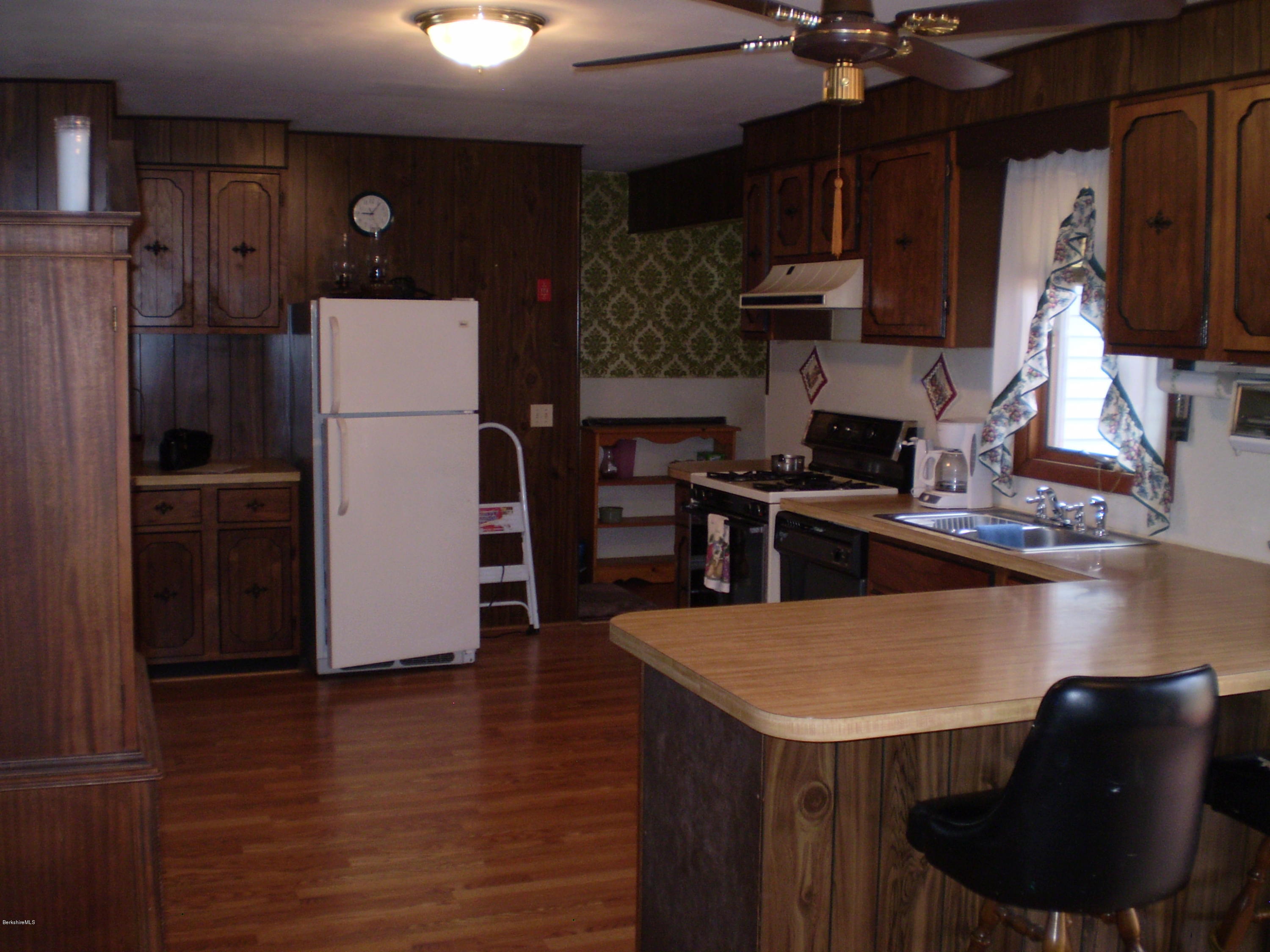 45 N Road Peru, MA 01235 - Photo 22 of 68 a kitchen with kitchen island a counter top space cabinets and stainless steel appliances