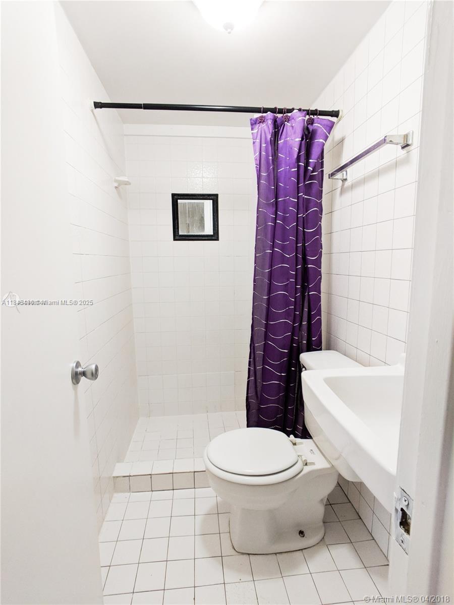 2433 Southwest 11th Street, Unit B Miami, FL 33135 - Photo 2 of 8 a white toilet sitting next to a bath tub