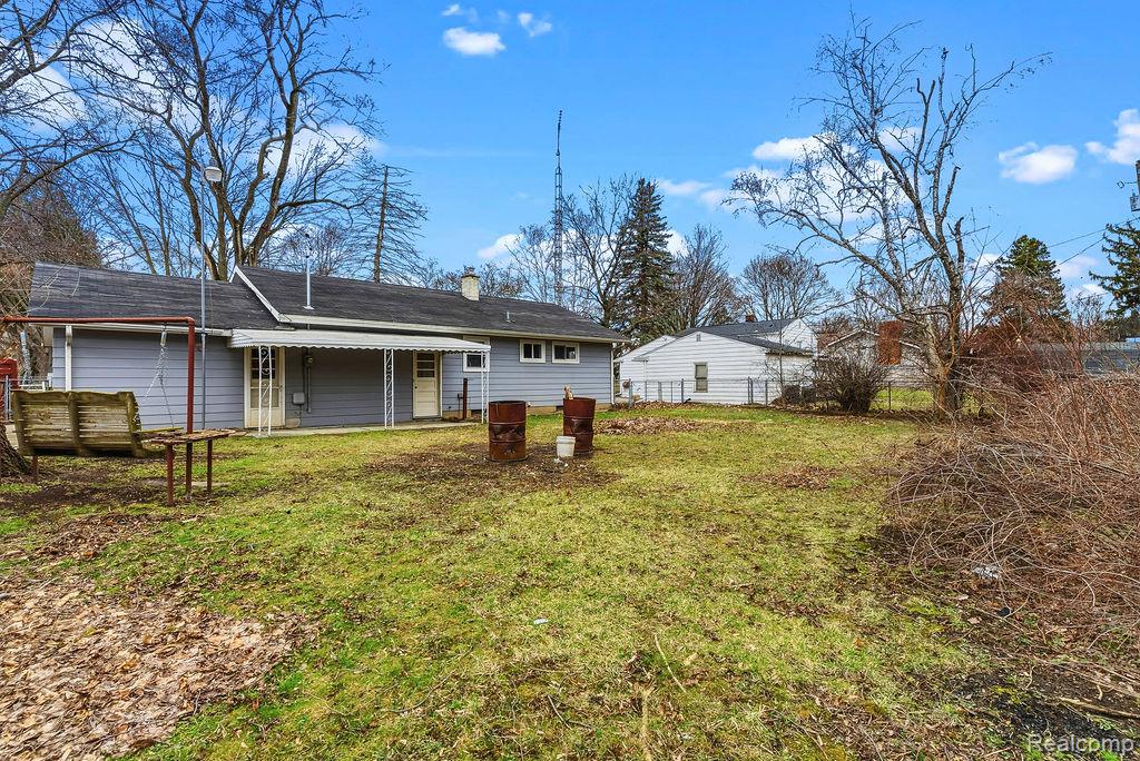 3485 Hammerberg Road Flint, MI 48507 - Photo 32 of 35 Rear view of property featuring a chimney and a patio