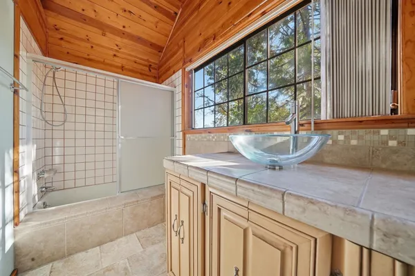a room with a sink and chandelier