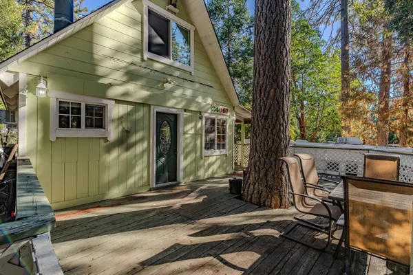 a view of a house with a tree in the yard