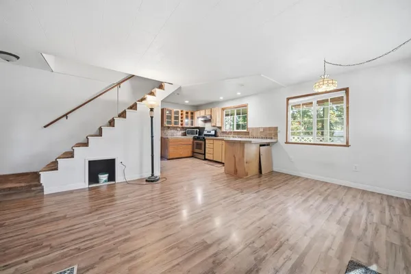 a view of a kitchen with furniture wooden floor and window