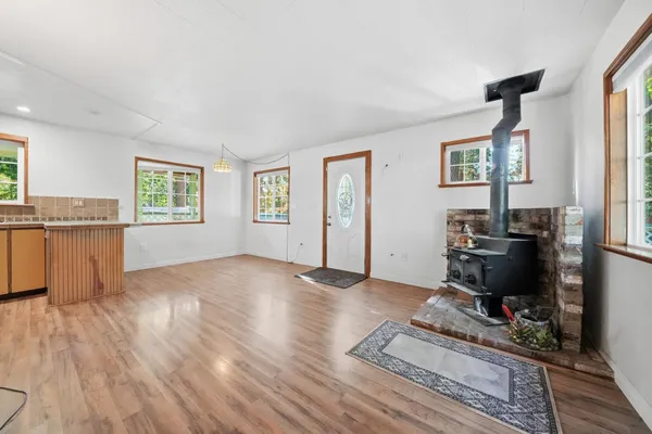 a view of a workspace with wooden floor and a window