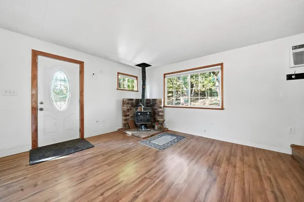 a view of a livingroom with wooden floor and a window