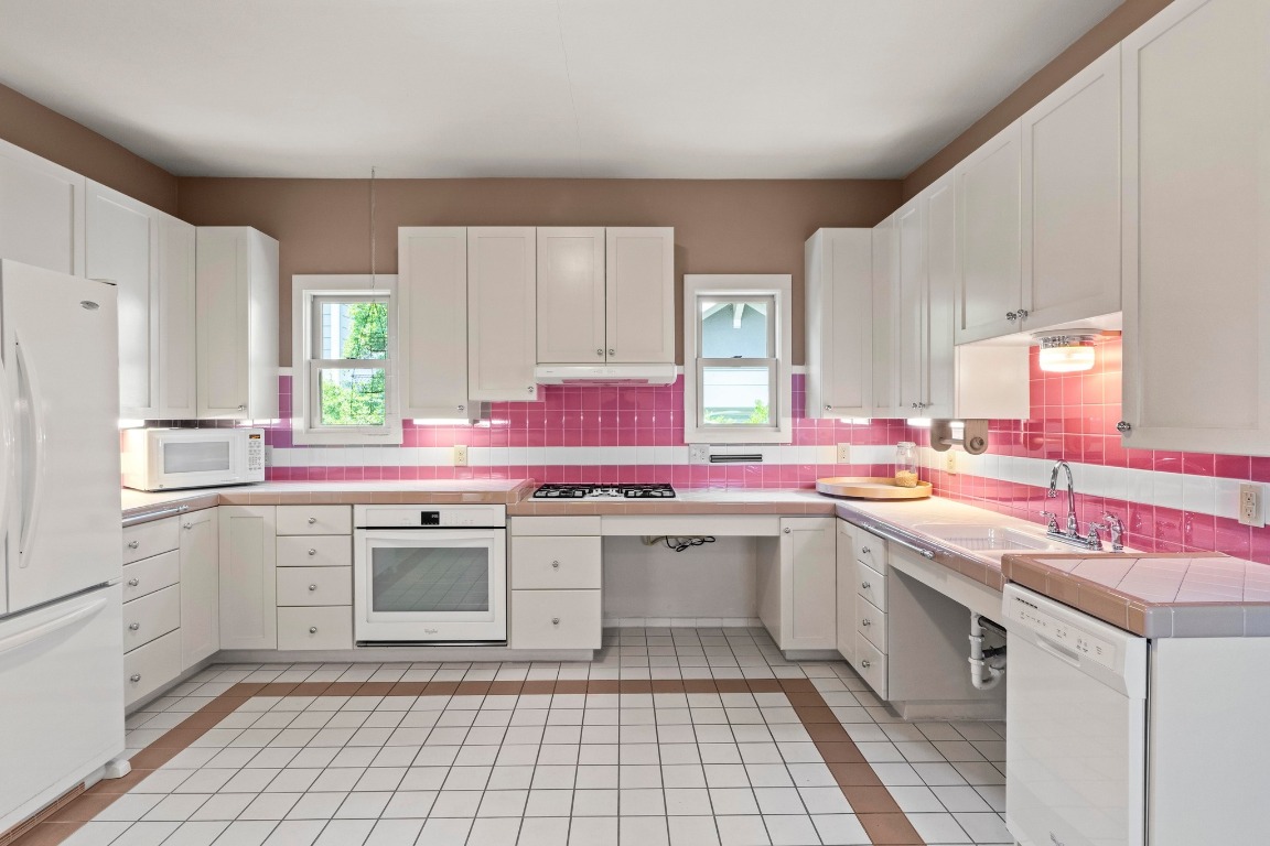 4314 Duval Street Austin, TX 78751 - Photo 11 of 33 a kitchen with a sink stove top oven and refrigerator