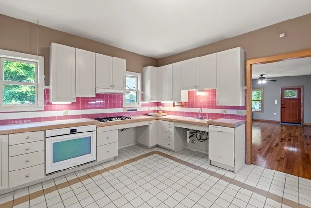 a kitchen with a sink cabinets and window