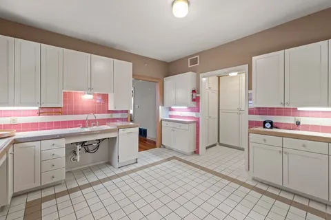 a kitchen with a sink cabinets and appliances