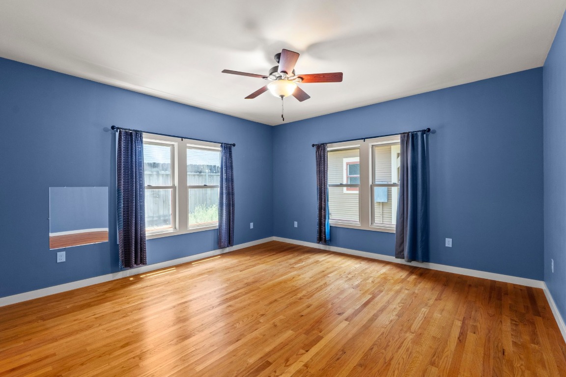 4314 Duval Street Austin, TX 78751 - Photo 14 of 33 a view of an empty room with window and wooden floor