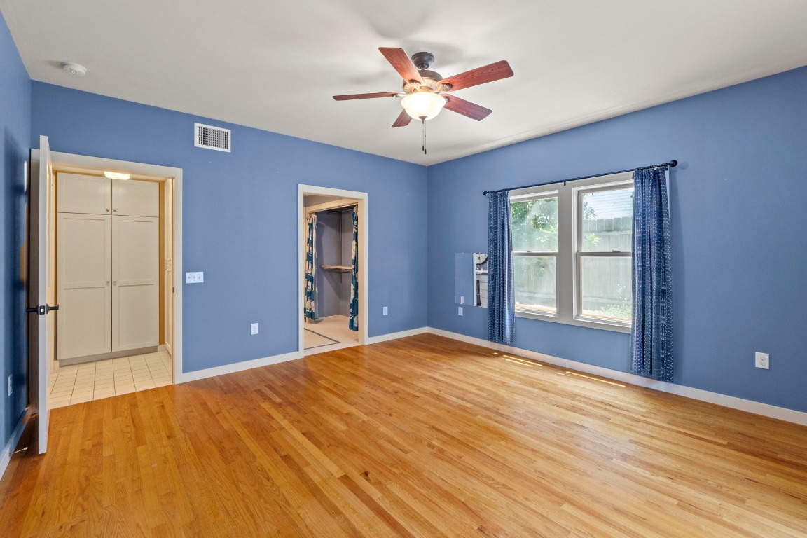 4314 Duval Street Austin, TX 78751 - Photo 15 of 33 a bedroom with a bed and a chandelier