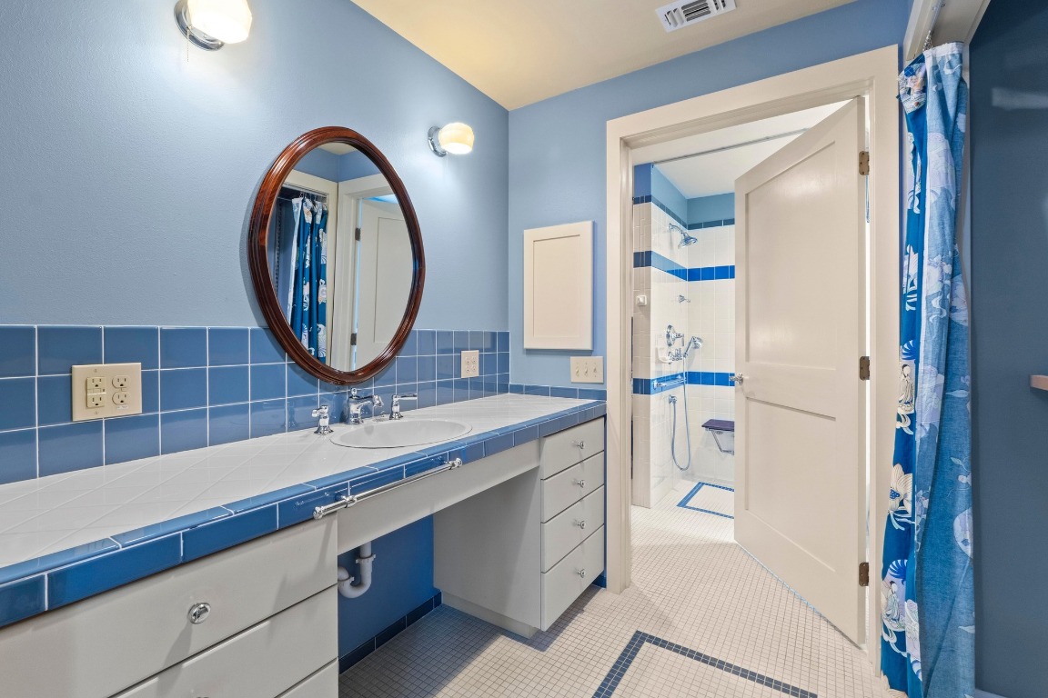 4314 Duval Street Austin, TX 78751 - Photo 16 of 33 a bathroom with a sink and a mirror