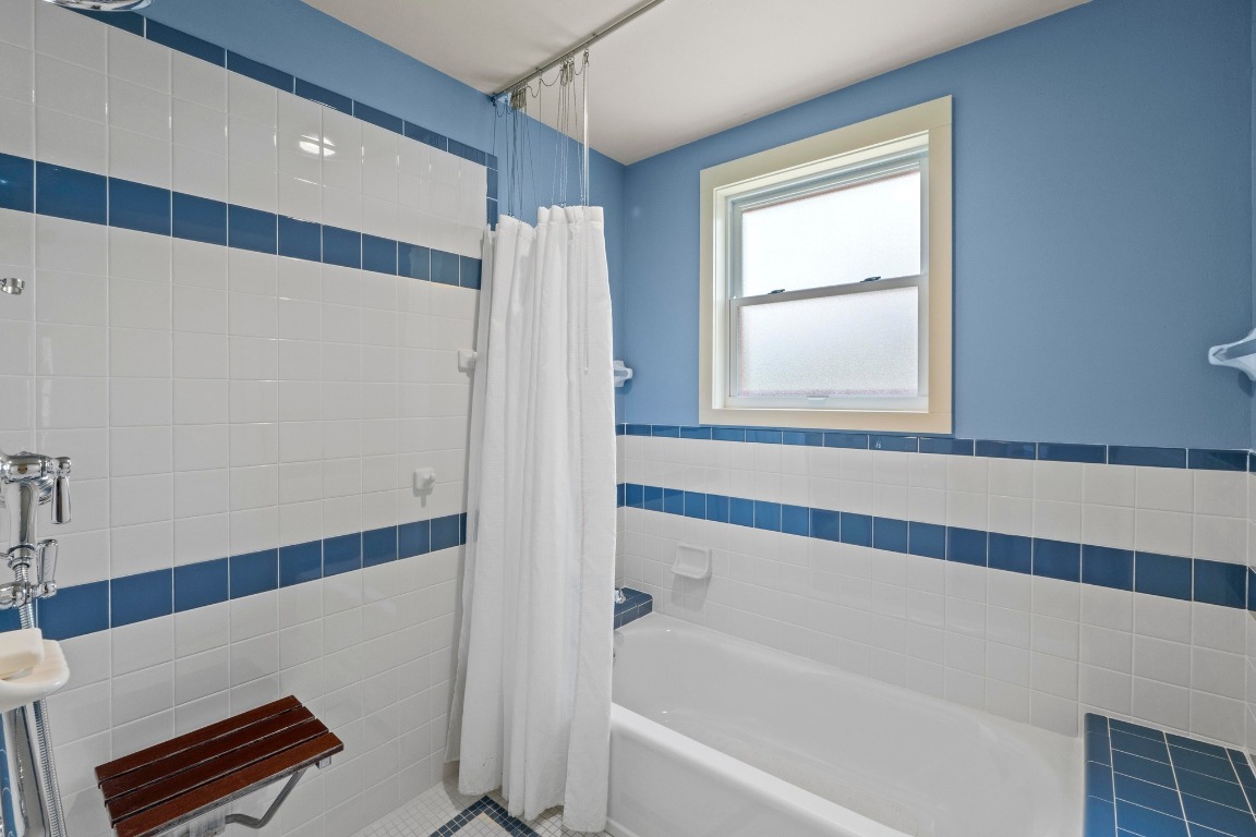4314 Duval Street Austin, TX 78751 - Photo 19 of 33 a bathroom with a bathtub and a shower