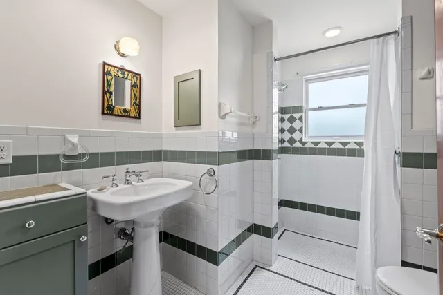 a view of a balcony with wooden floor and iron stairs
