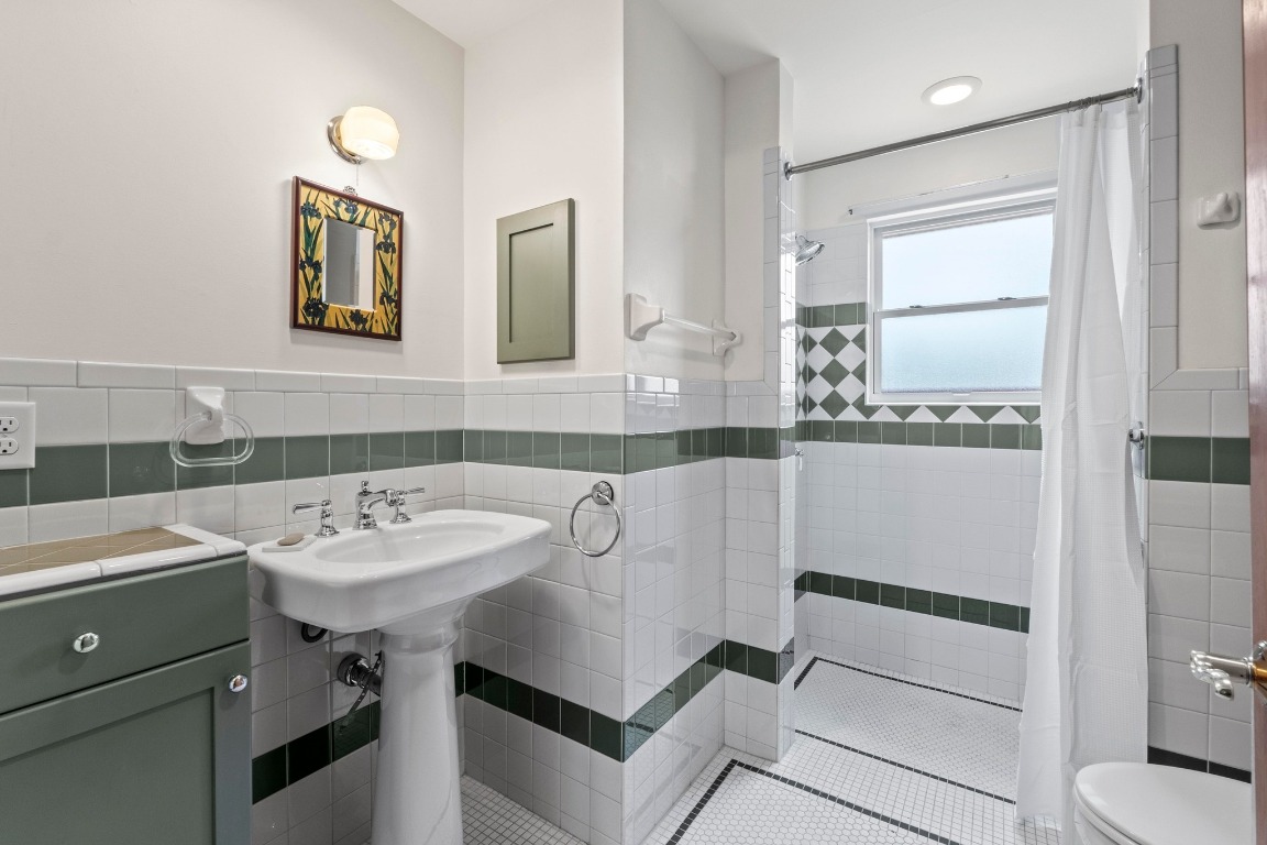 4314 Duval Street Austin, TX 78751 - Photo 22 of 33 a bathroom with a sink and a mirror