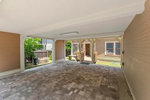 a view of a house with a wooden deck and a yard