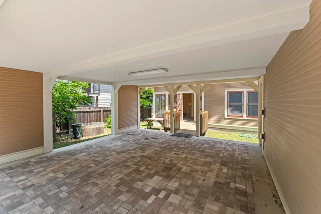 a view of a house with a wooden deck and a yard