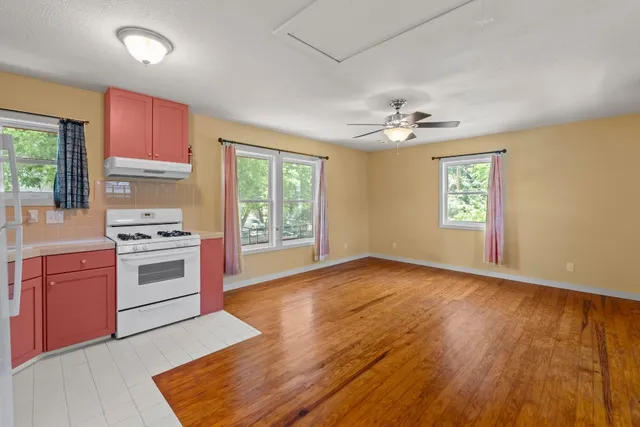 a view of a kitchen with a stove cabinets and wooden floor