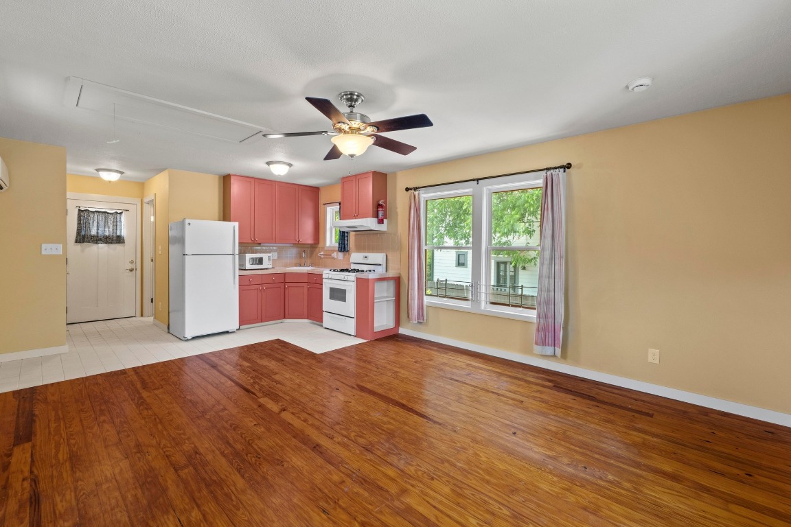 4314 Duval Street Austin, TX 78751 - Photo 29 of 33 a view of a kitchen with a stove cabinets and wooden floor