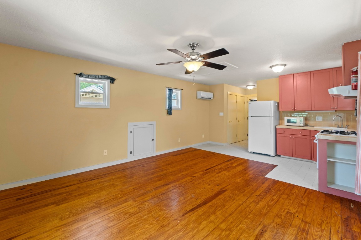 4314 Duval Street Austin, TX 78751 - Photo 30 of 33 a big room with wooden floor and kitchen view