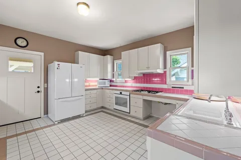 a kitchen with a sink cabinets and stainless steel appliances