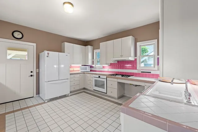 a kitchen with a sink cabinets and stainless steel appliances