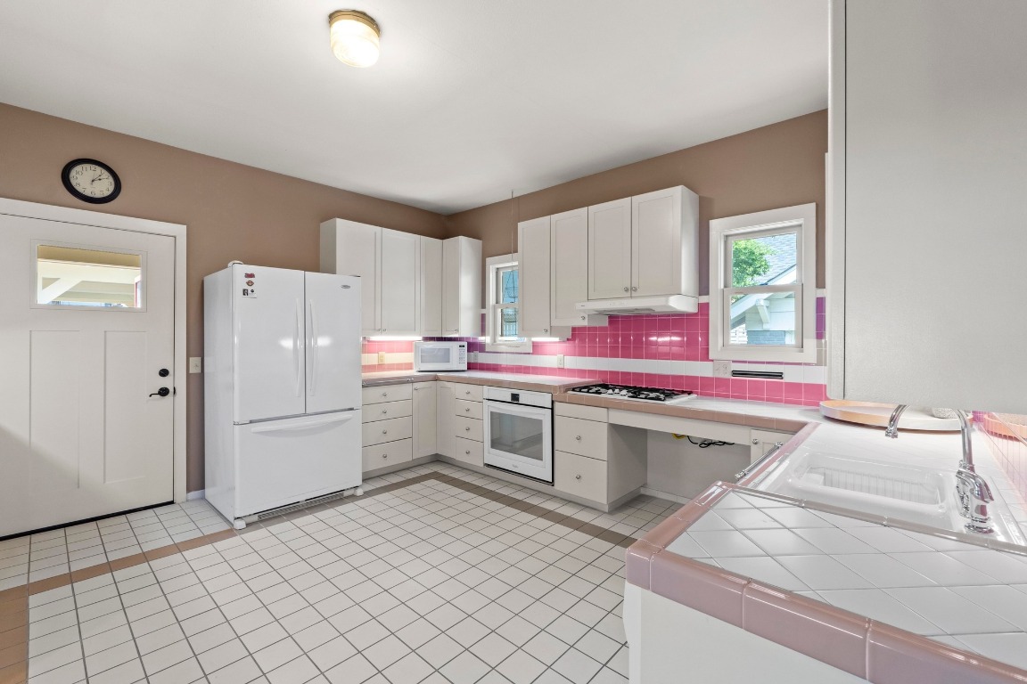 4314 Duval Street Austin, TX 78751 - Photo 10 of 33 a kitchen with a sink cabinets and stainless steel appliances