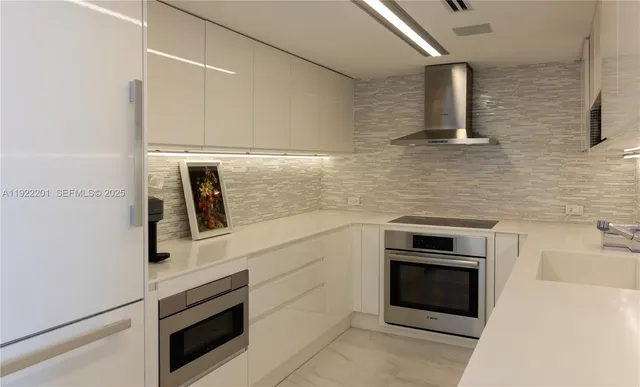 a kitchen with cabinets and stainless steel appliances