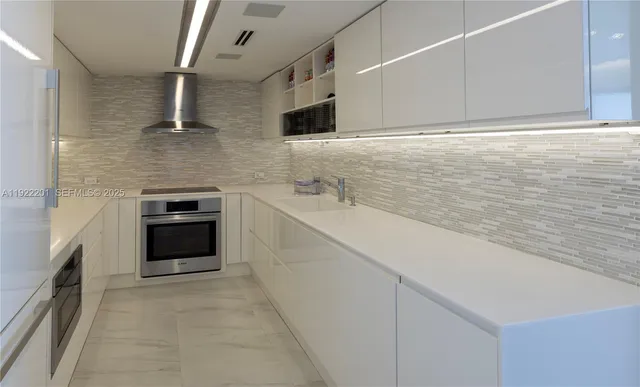 a kitchen with a sink stove and cabinets