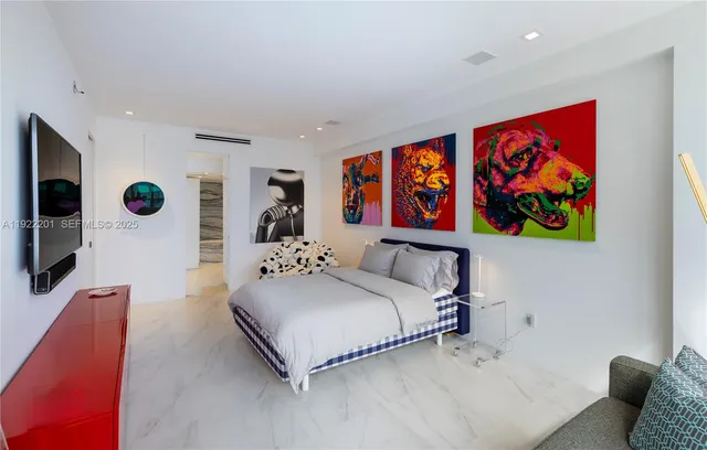 a bedroom with a bed and a couch