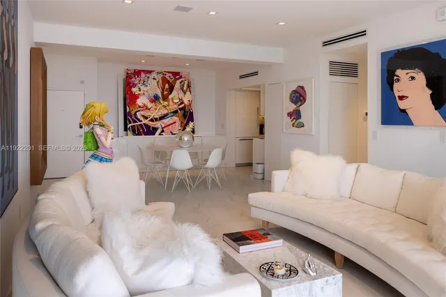 a living room with furniture and wall painting