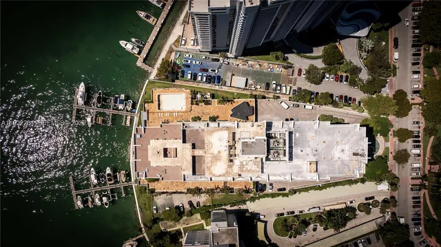 a room with pool table and large windows